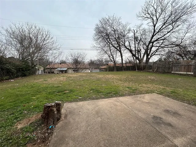 a view of a field with an trees