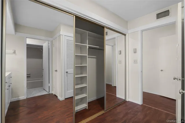 a white toilet sitting next to a bath tub