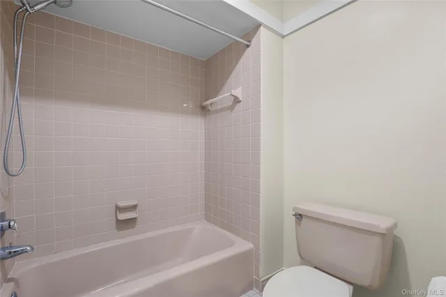 a view of empty room with wooden floor and window