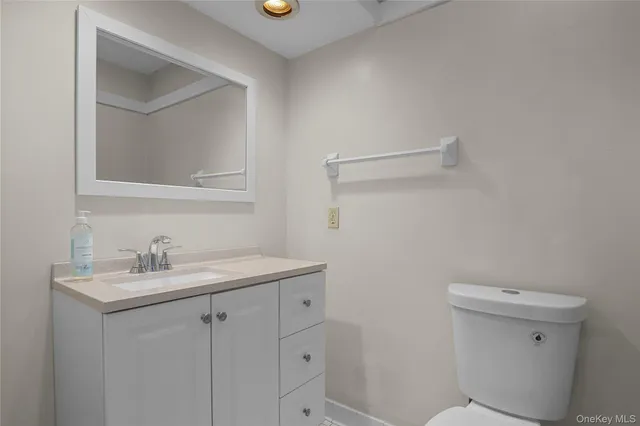 a white toilet sitting next to a shower