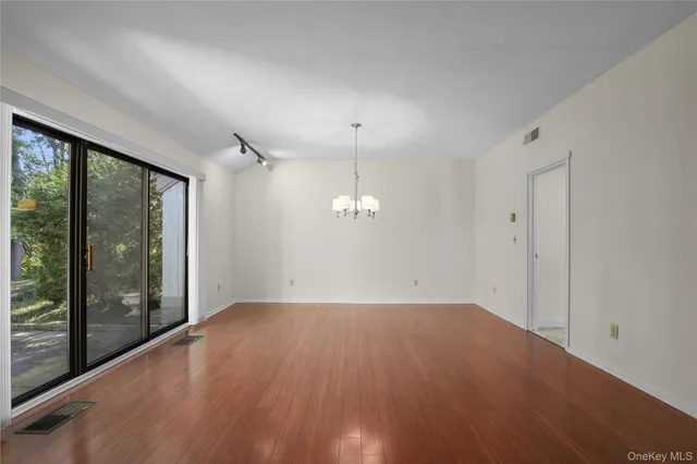 en empty room with windows and outdoor view