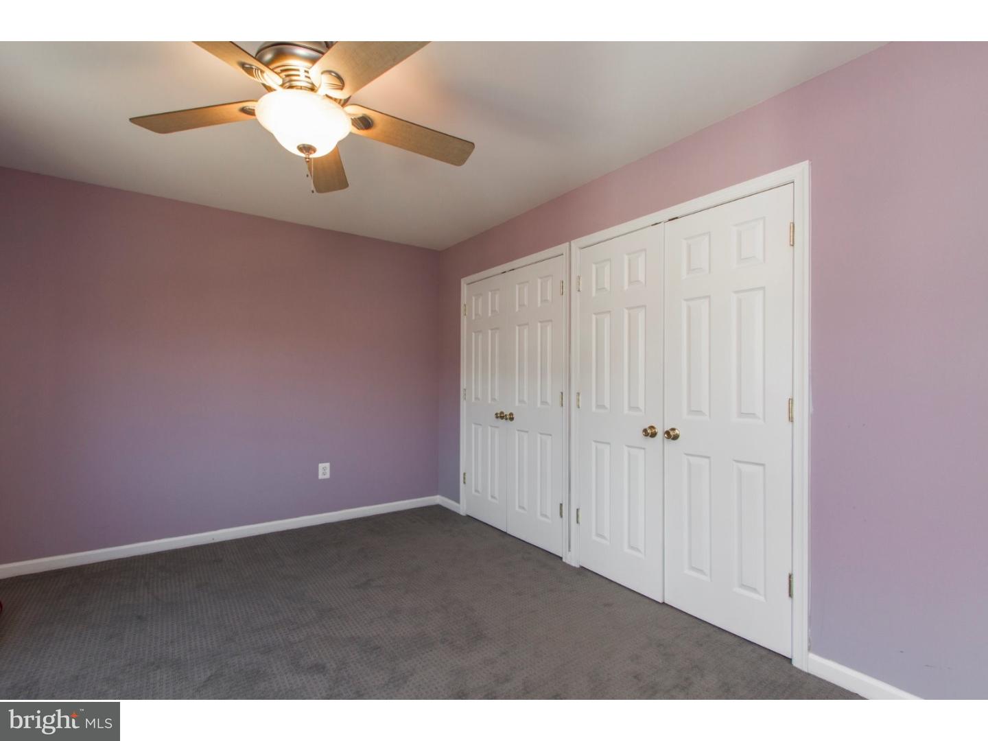 1728 Ridgeway Road Havertown, PA 19083 - Photo 21 of 25 an empty room with a chandelier fan and windows