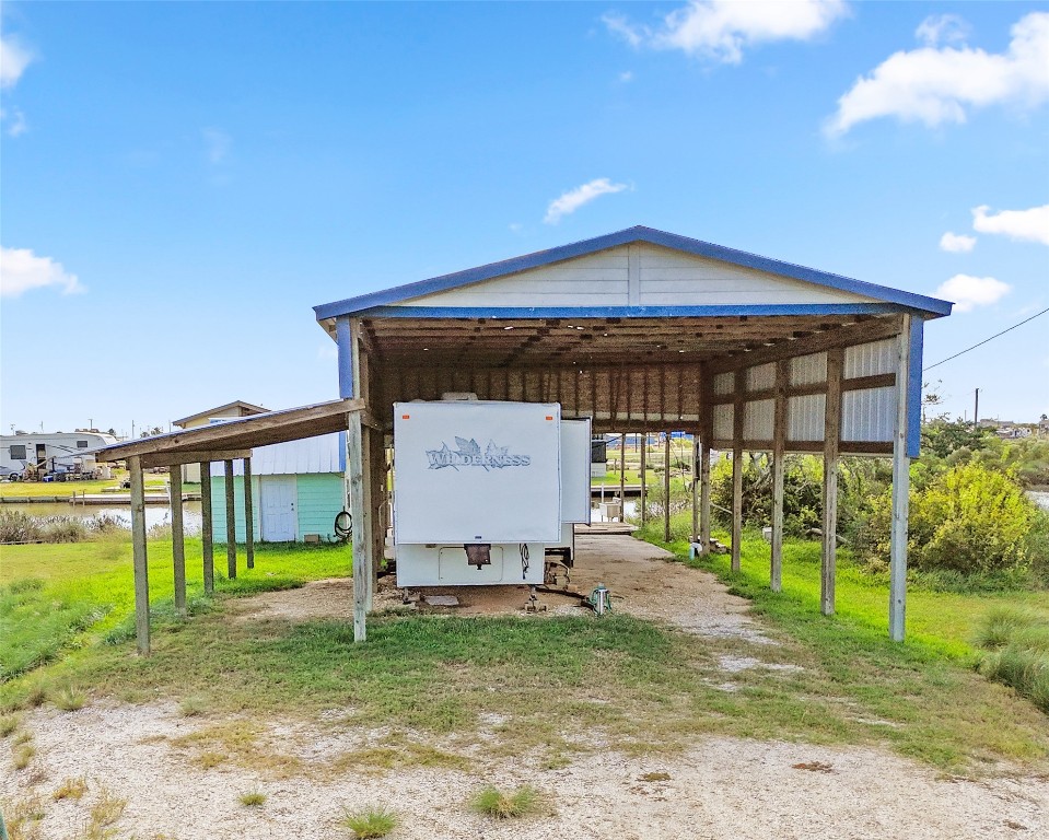 14507 Chimaera Road Sargent, TX 77414 - Photo 2 of 27 a view of a house with a yard