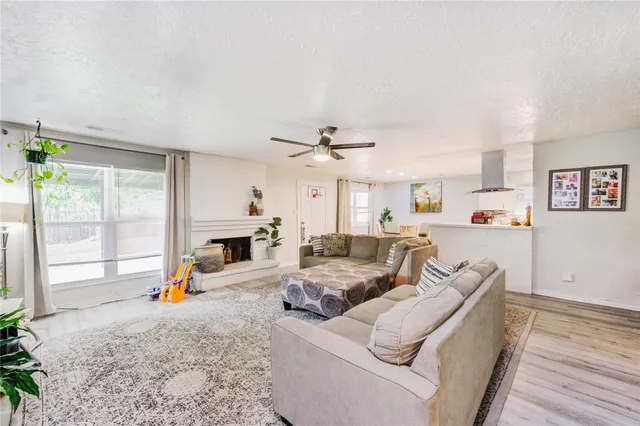 a living room with furniture a fireplace and a table