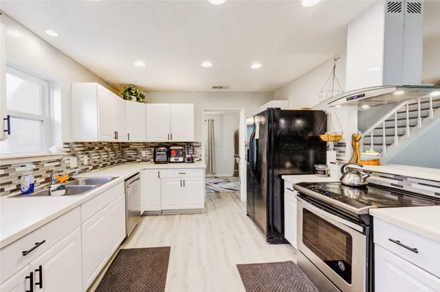 a kitchen with a sink stove and refrigerator