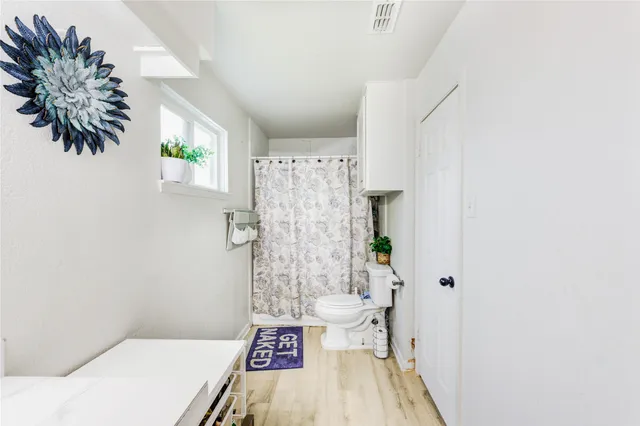 a bathroom with a toilet and a shower
