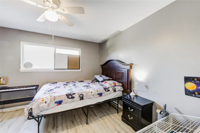 a bedroom with a bed and a tv on the dresser