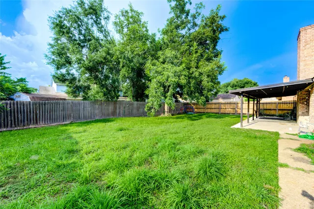 a view of a backyard with sitting area