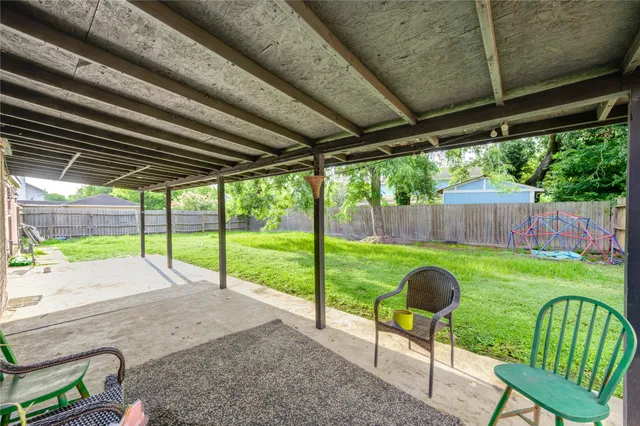 a view of a backyard with chairs and a backyard