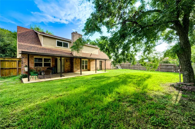 a view of a house with backyard porch and garden