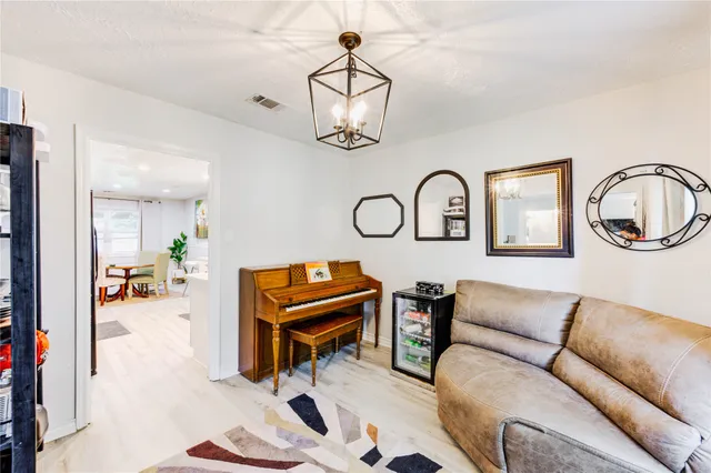 a living room with furniture a rug and a chandelier