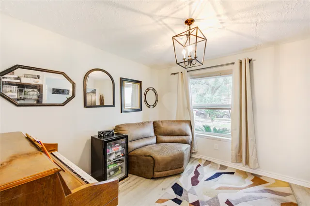 a living room with furniture a window and a chandelier