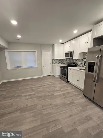 a large kitchen with stainless steel appliances