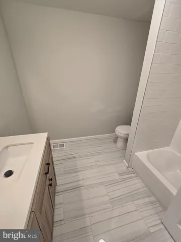 a bathroom with a sink and toilet