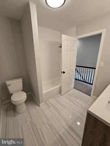 a bathroom with a toilet a sink and a bathtub