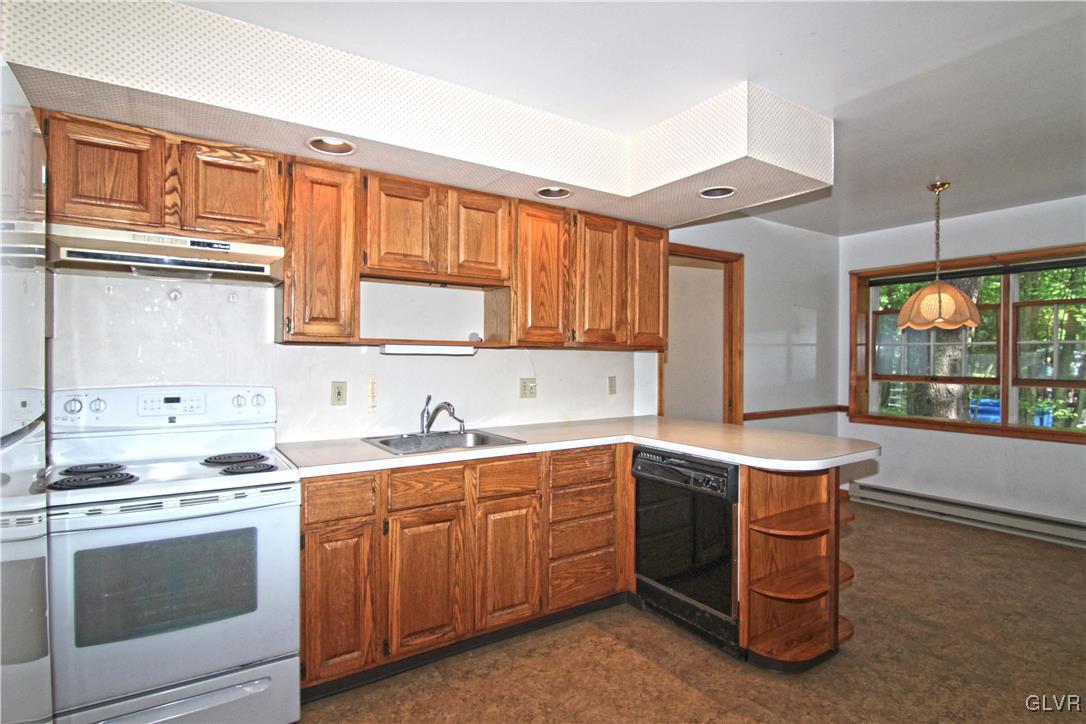 3246 Willow Grove Road Pocono Summit, PA 18346 - Photo 11 of 30 a kitchen with a sink stove and cabinets