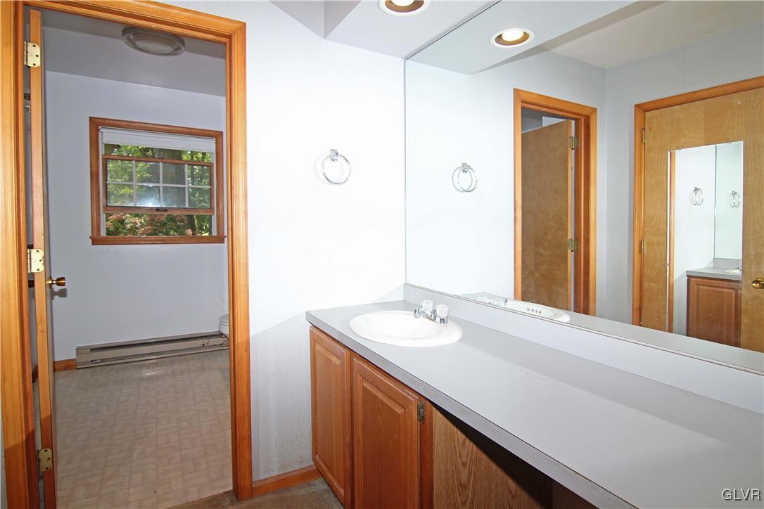 3246 Willow Grove Road Pocono Summit, PA 18346 - Photo 15 of 30 a bathroom with a sink vanity and a mirror
