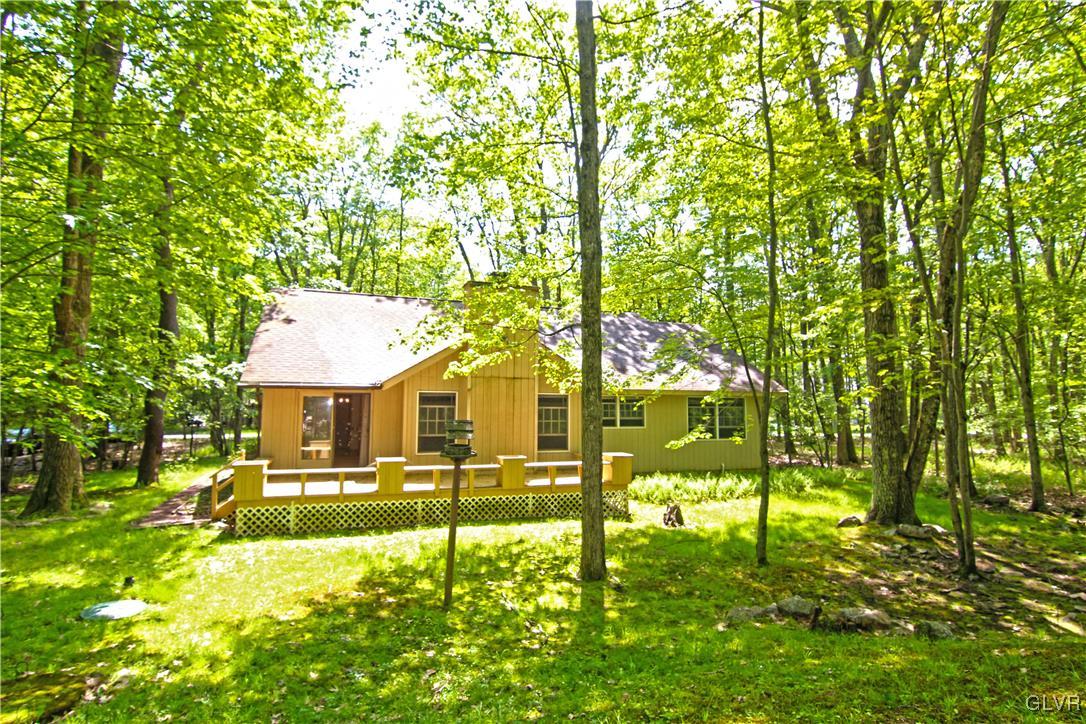 3246 Willow Grove Road Pocono Summit, PA 18346 - Photo 22 of 30 a front view of a house with a yard