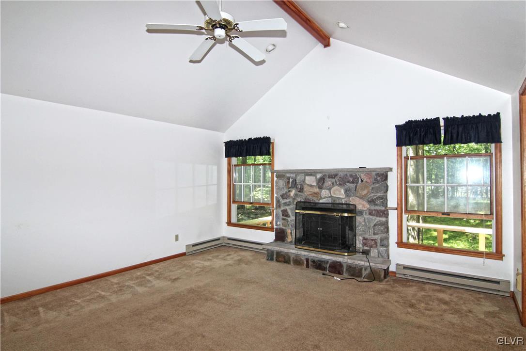 3246 Willow Grove Road Pocono Summit, PA 18346 - Photo 4 of 30 a living room with furniture and a fireplace