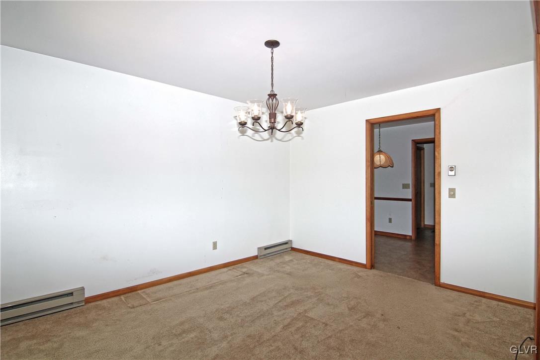 3246 Willow Grove Road Pocono Summit, PA 18346 - Photo 8 of 30 an empty room with chandelier fan and wooden floor