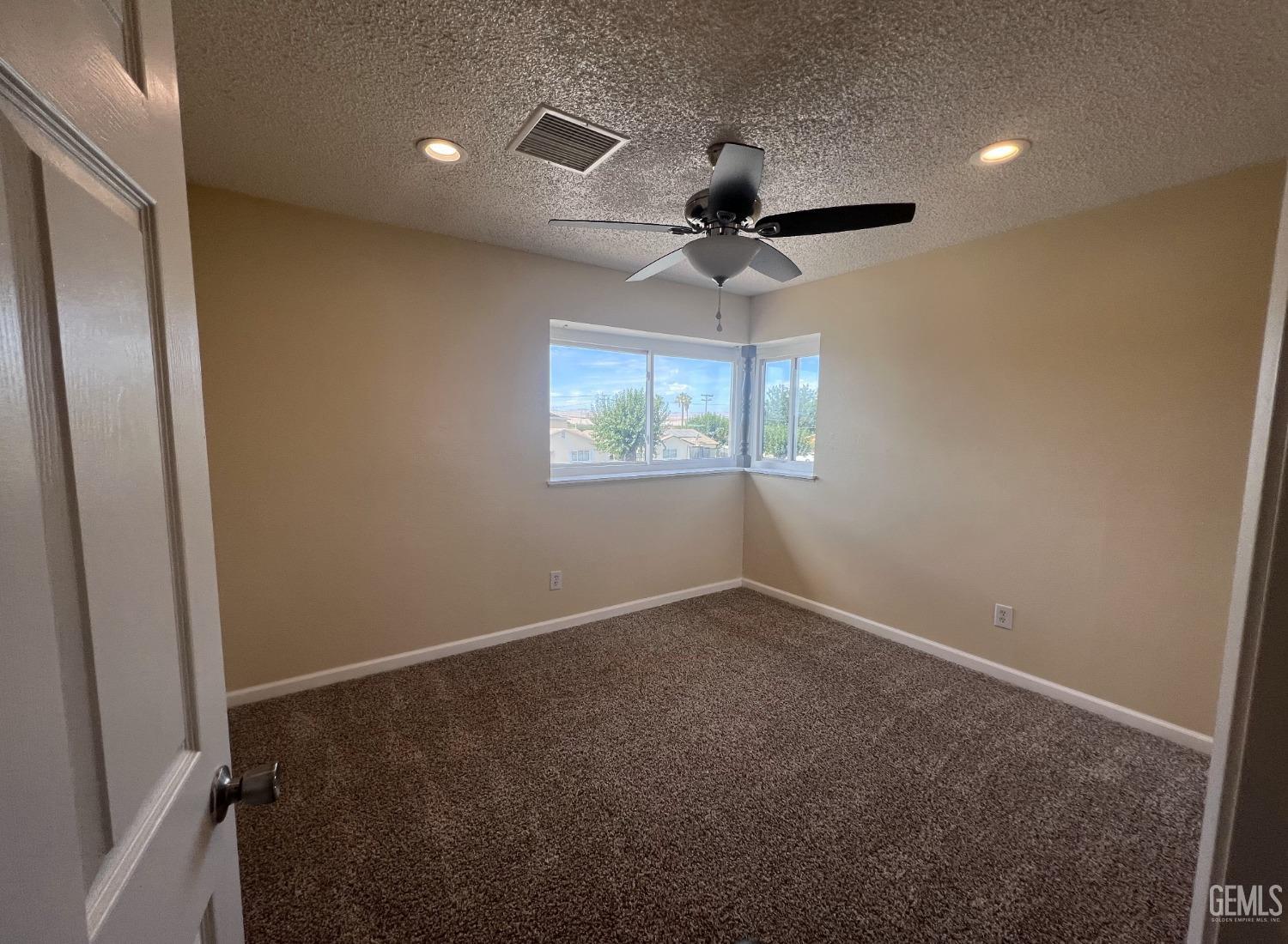 Undisclosed Address Buttonwillow, CA 93206 - Photo 15 of 24 an empty room with windows and fan