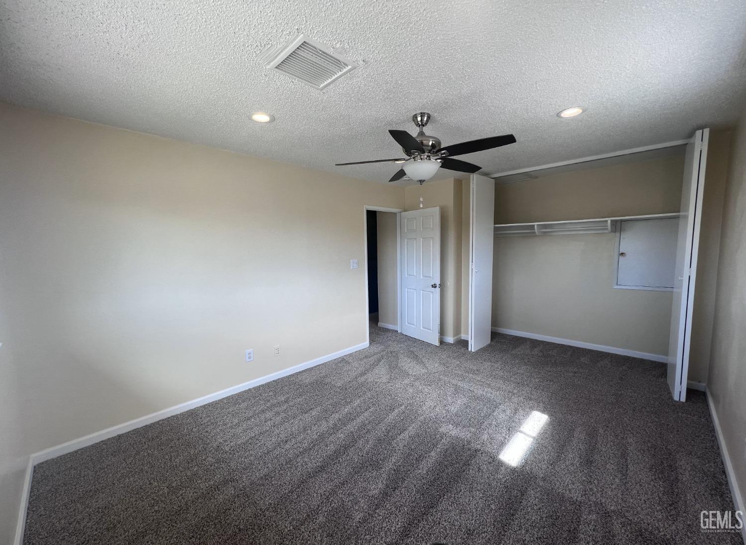 Undisclosed Address Buttonwillow, CA 93206 - Photo 17 of 24 an empty room with a empty space and a ceiling fan