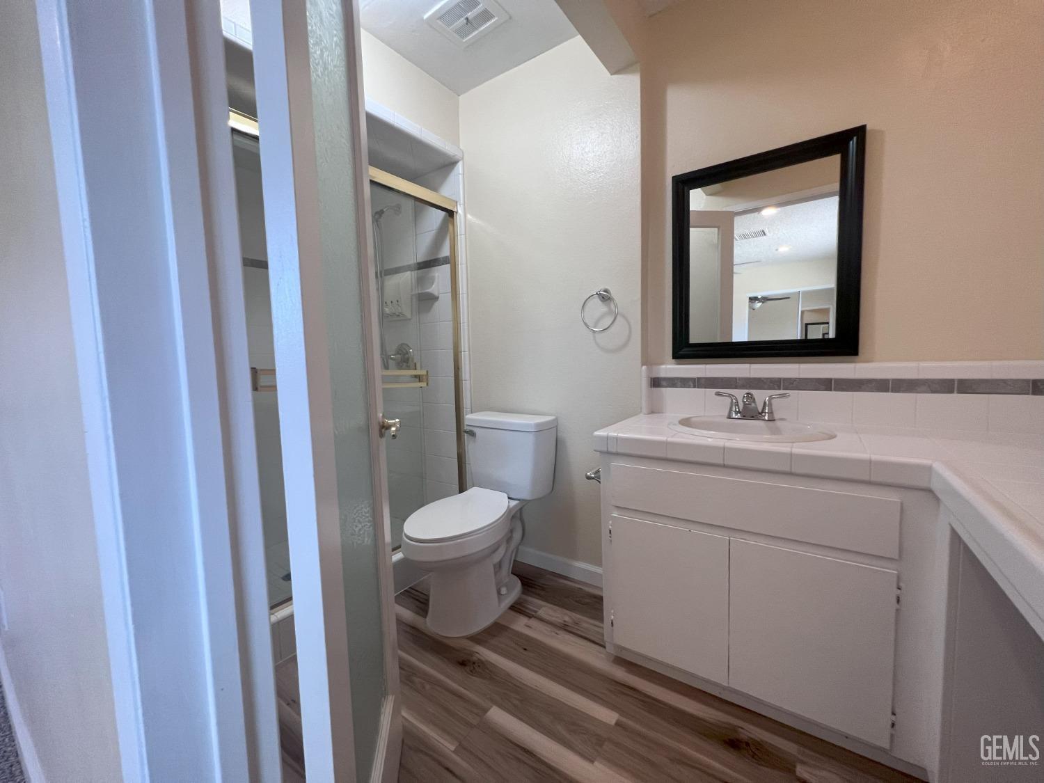 Undisclosed Address Buttonwillow, CA 93206 - Photo 19 of 24 a bathroom with a toilet sink and mirror