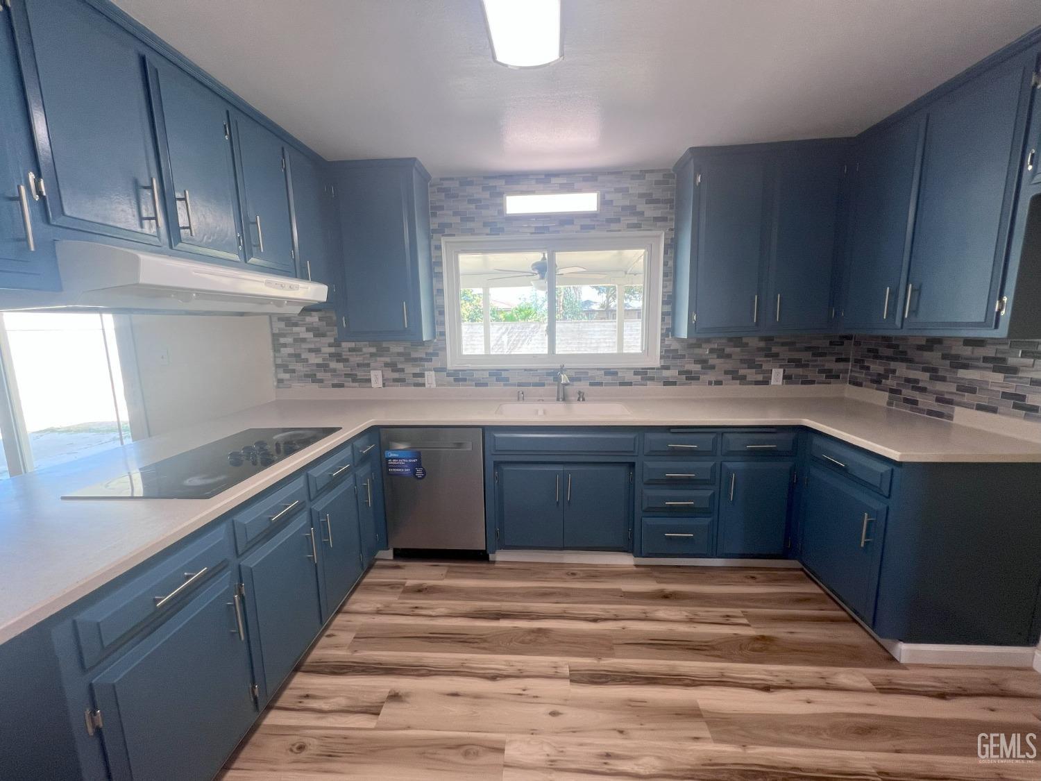 Undisclosed Address Buttonwillow, CA 93206 - Photo 23 of 24 a kitchen with granite countertop wooden cabinets and white appliances