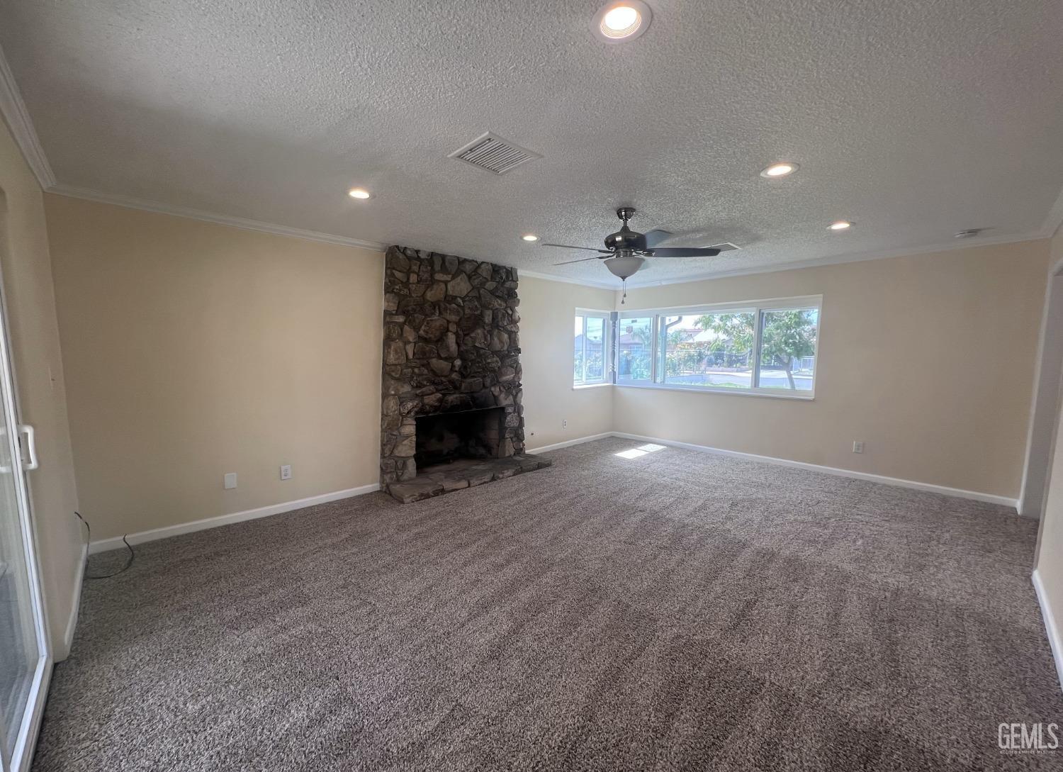 Undisclosed Address Buttonwillow, CA 93206 - Photo 5 of 24 an empty room with windows and fireplace