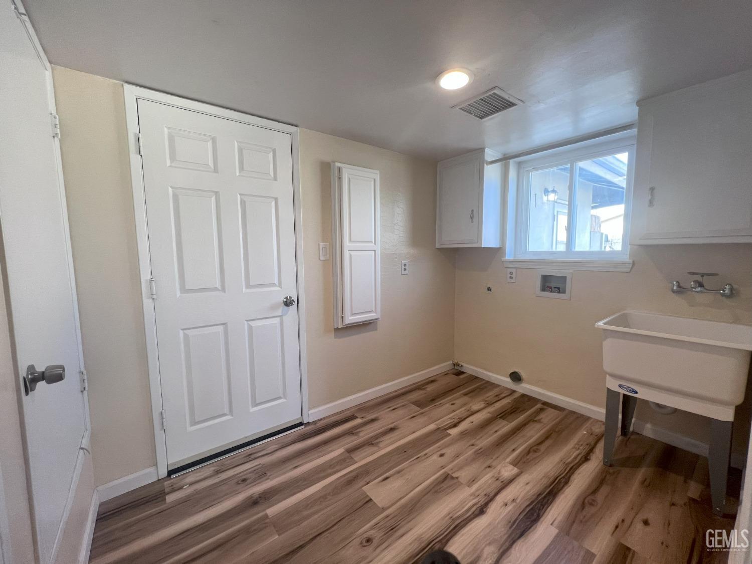Undisclosed Address Buttonwillow, CA 93206 - Photo 8 of 24 a view of a room with wooden floor and cabinets