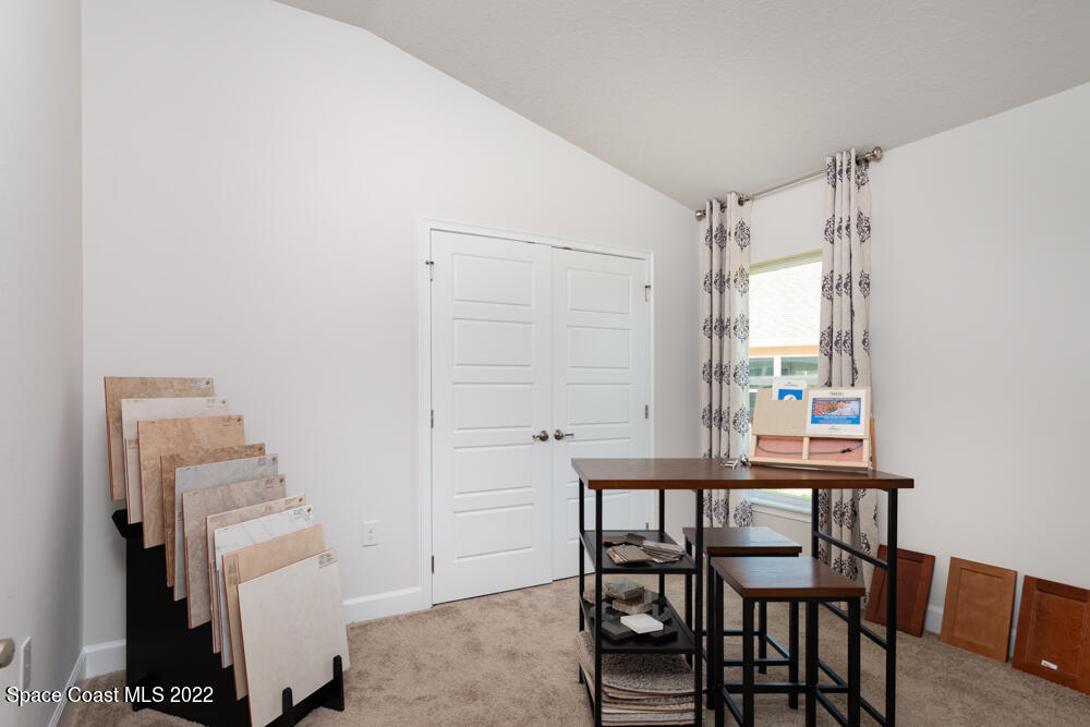401 Scarlet Road Southwest Palm Bay, FL 32908 - Photo 18 of 24 a dining room with furniture and a window