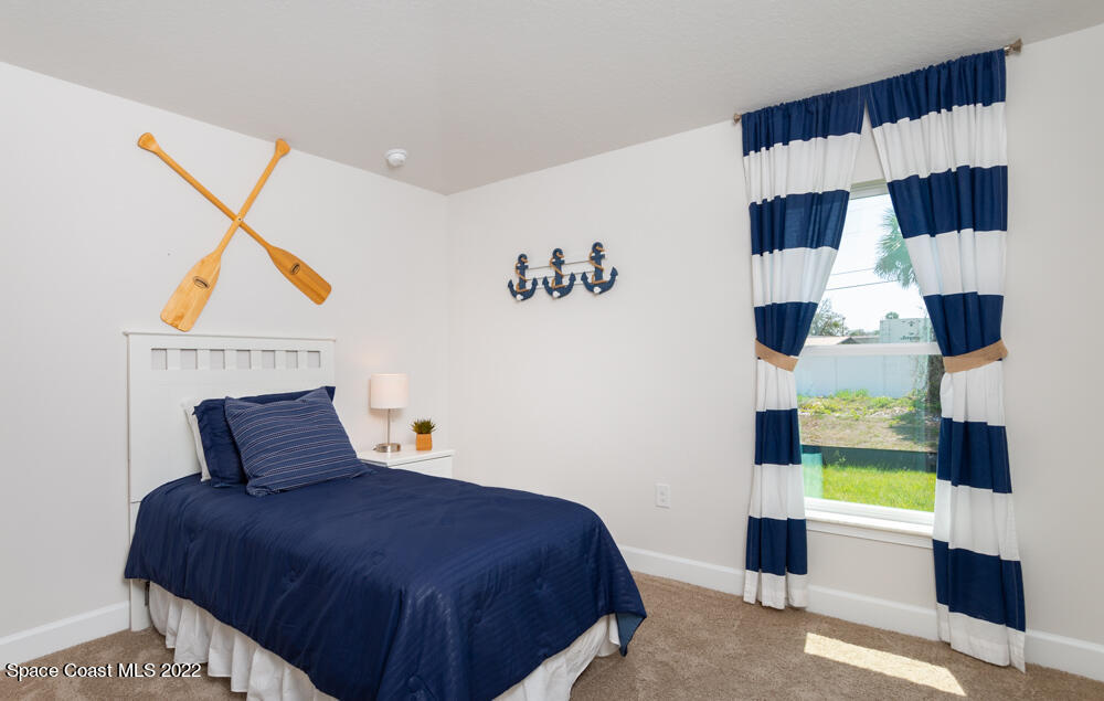 401 Scarlet Road Southwest Palm Bay, FL 32908 - Photo 19 of 24 a bedroom with a bed and a window