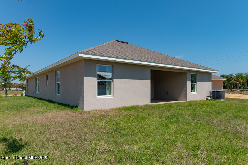 401 Scarlet Road Southwest Palm Bay, FL 32908 - Photo 21 of 24 a front view of house with yard and trees