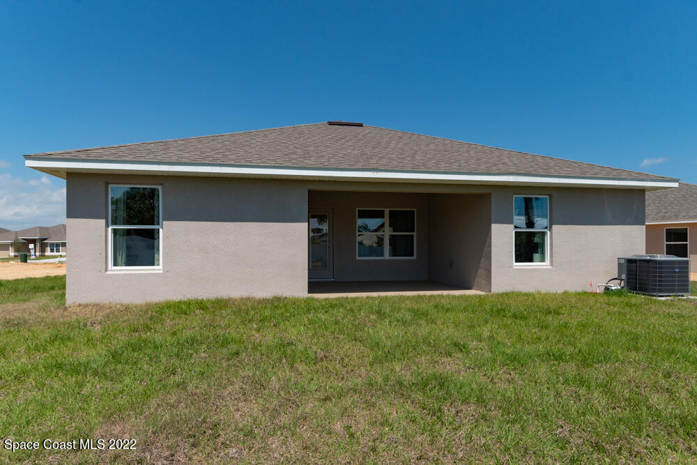 401 Scarlet Road Southwest Palm Bay, FL 32908 - Photo 22 of 24 a house that has a big yard in front of it