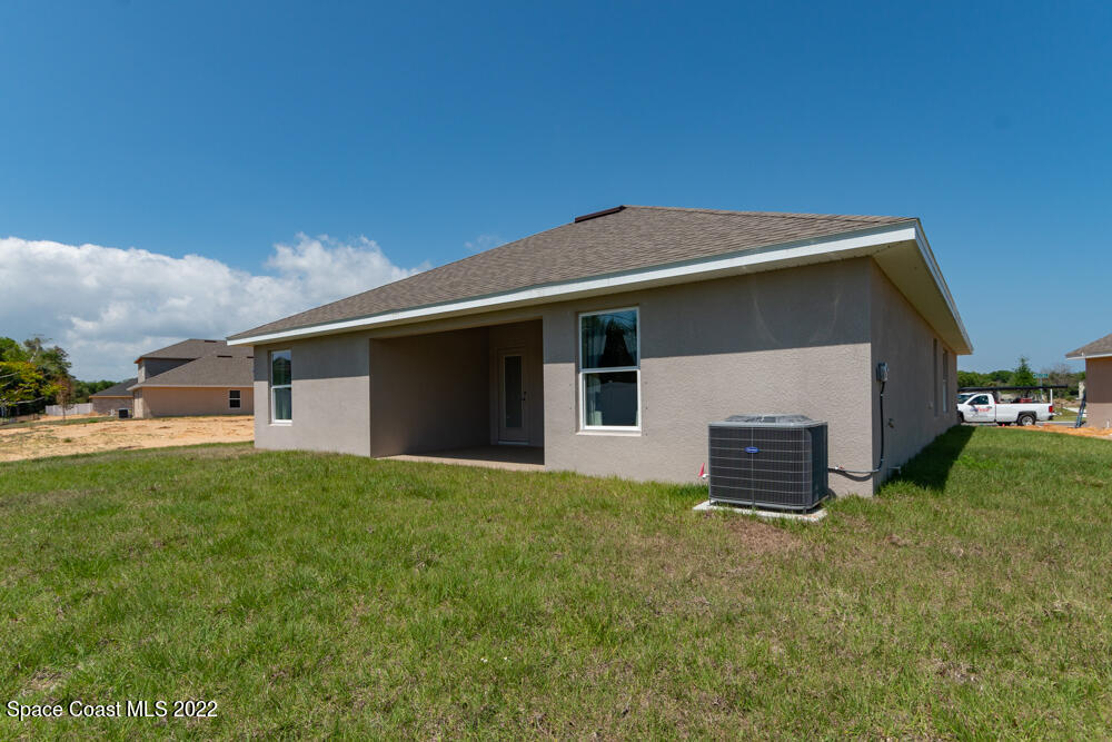 401 Scarlet Road Southwest Palm Bay, FL 32908 - Photo 23 of 24 a house that is sitting in the grass