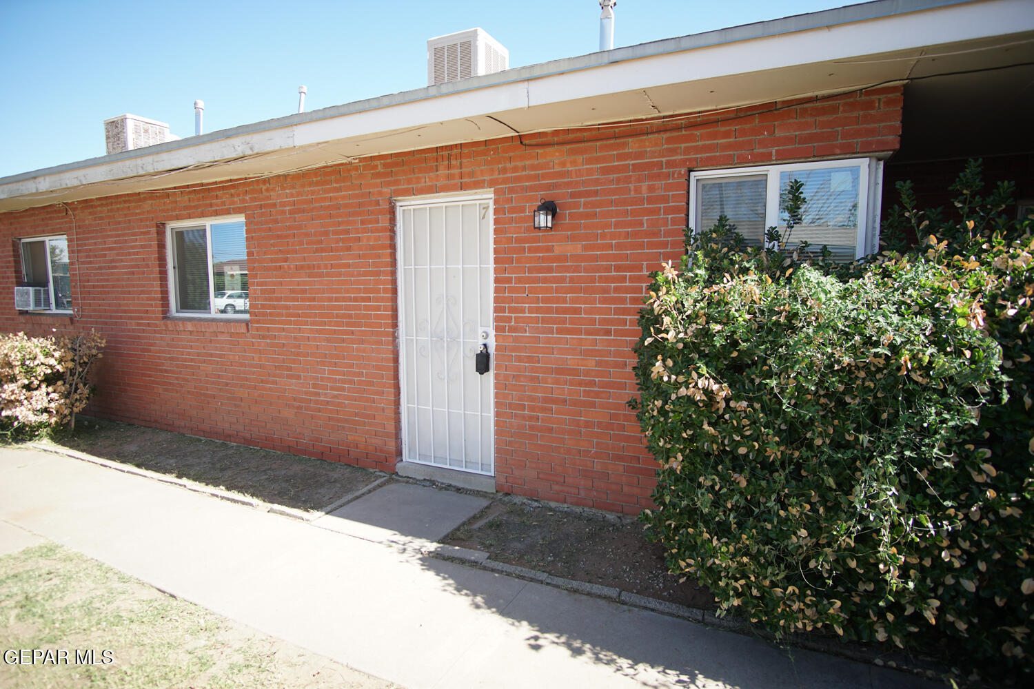 1421 St Johns Drive, Unit 7 El Paso, TX 79903 - Photo 1 of 12 a front view of a house with trees