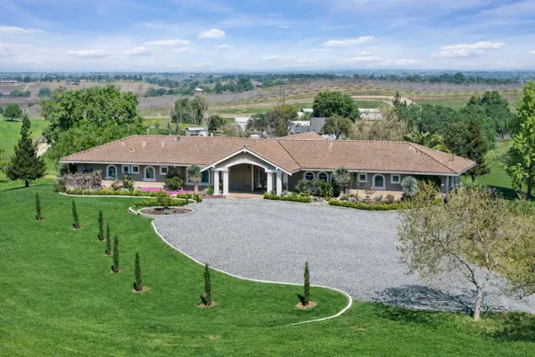 a aerial view of a house with swimming pool and a yard
