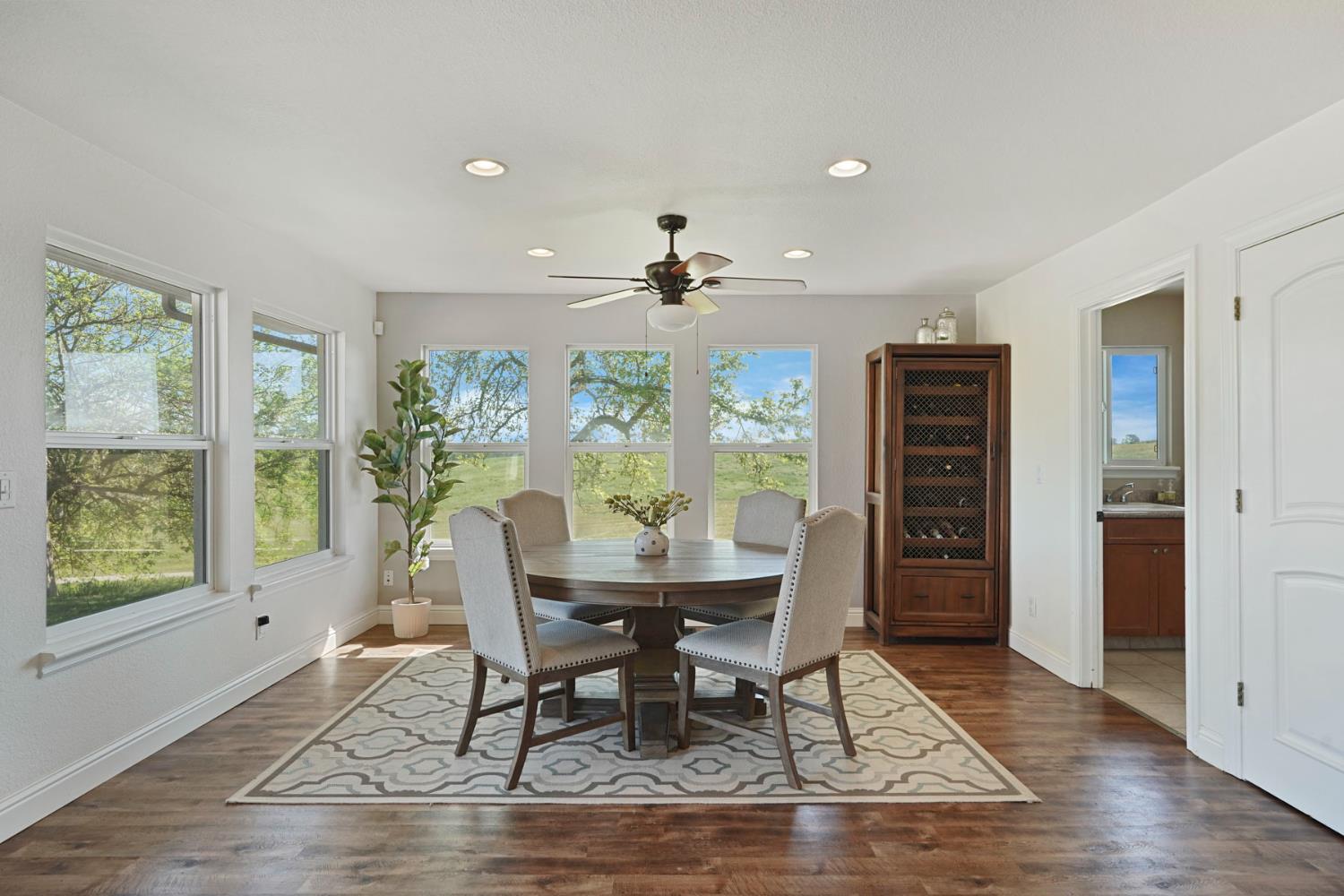 20820 East Acampo Road Clements, CA 95227 - Photo 15 of 28 a view of a dining room with furniture window and wooden floor