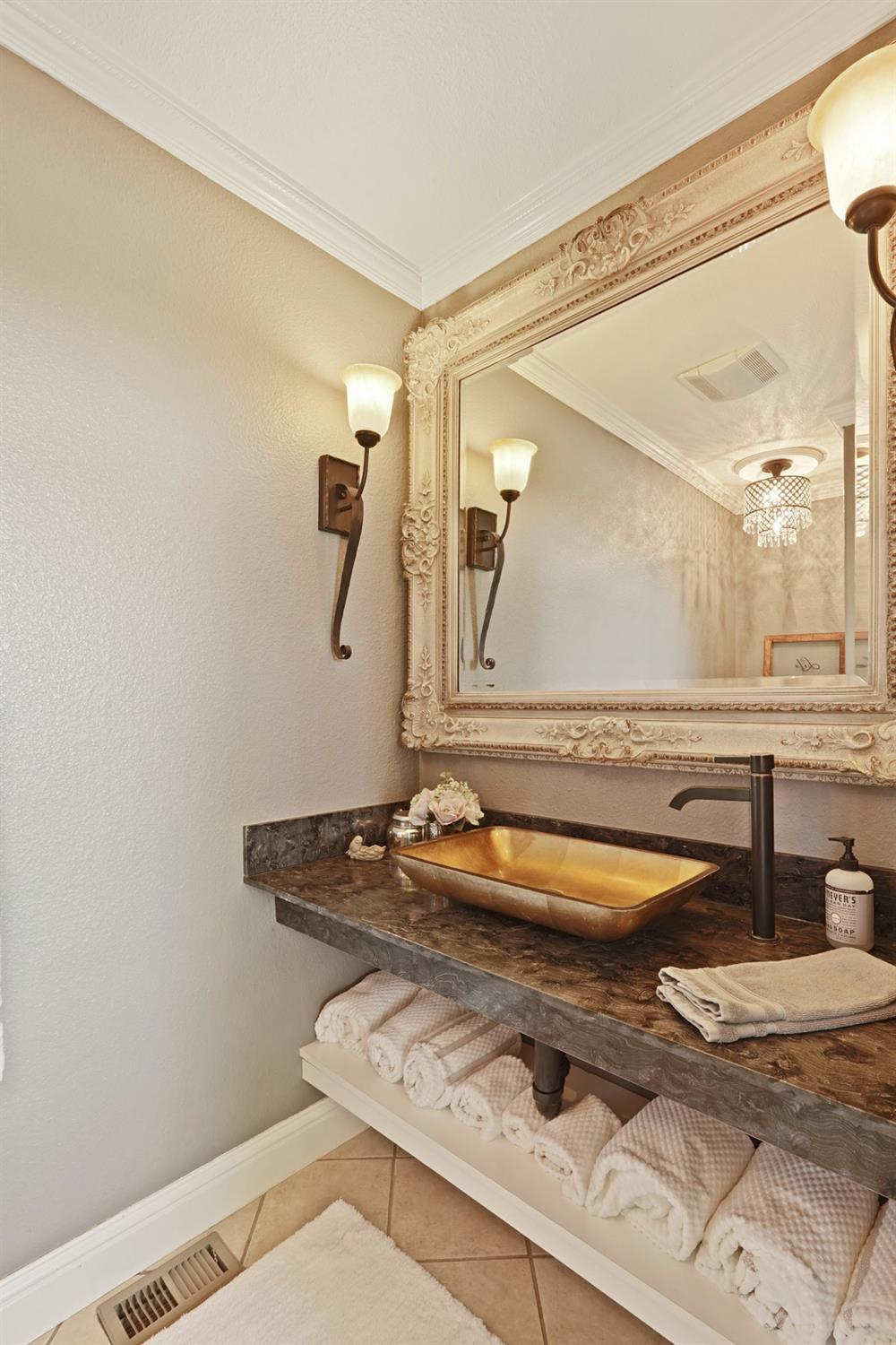 20820 East Acampo Road Clements, CA 95227 - Photo 17 of 28 a bathroom with a granite countertop toilet a sink and a mirror