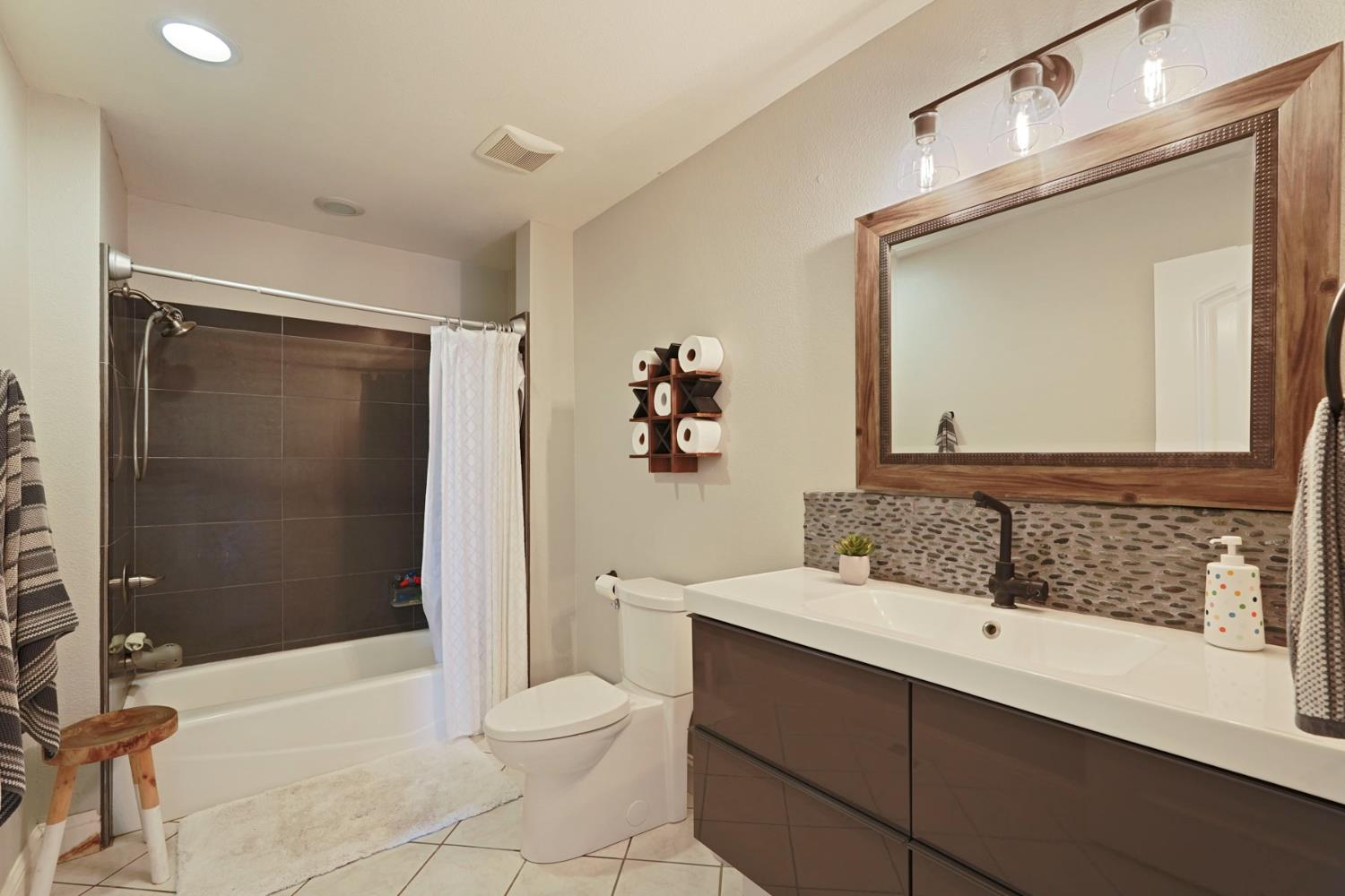 20820 East Acampo Road Clements, CA 95227 - Photo 19 of 28 a bathroom with a sink a toilet and shower