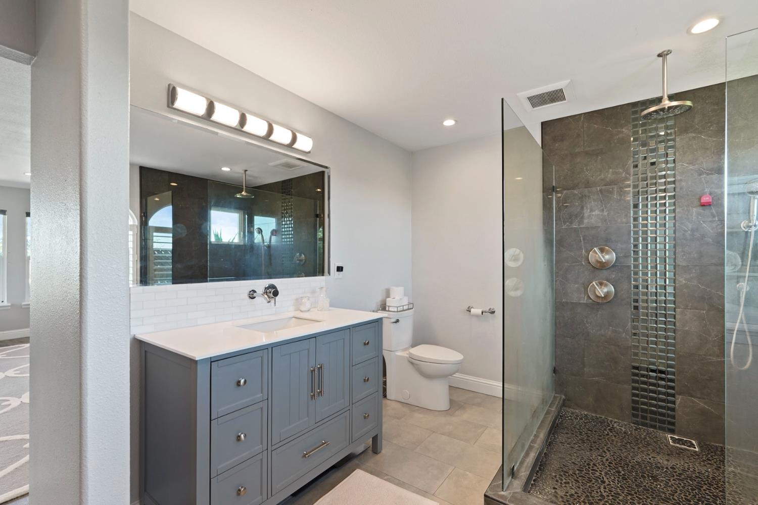 20820 East Acampo Road Clements, CA 95227 - Photo 23 of 28 a bathroom with a toilet a sink and mirror