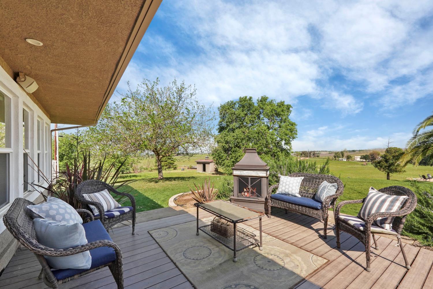 20820 East Acampo Road Clements, CA 95227 - Photo 25 of 28 a view of a patio with couches table and chairs and potted plants