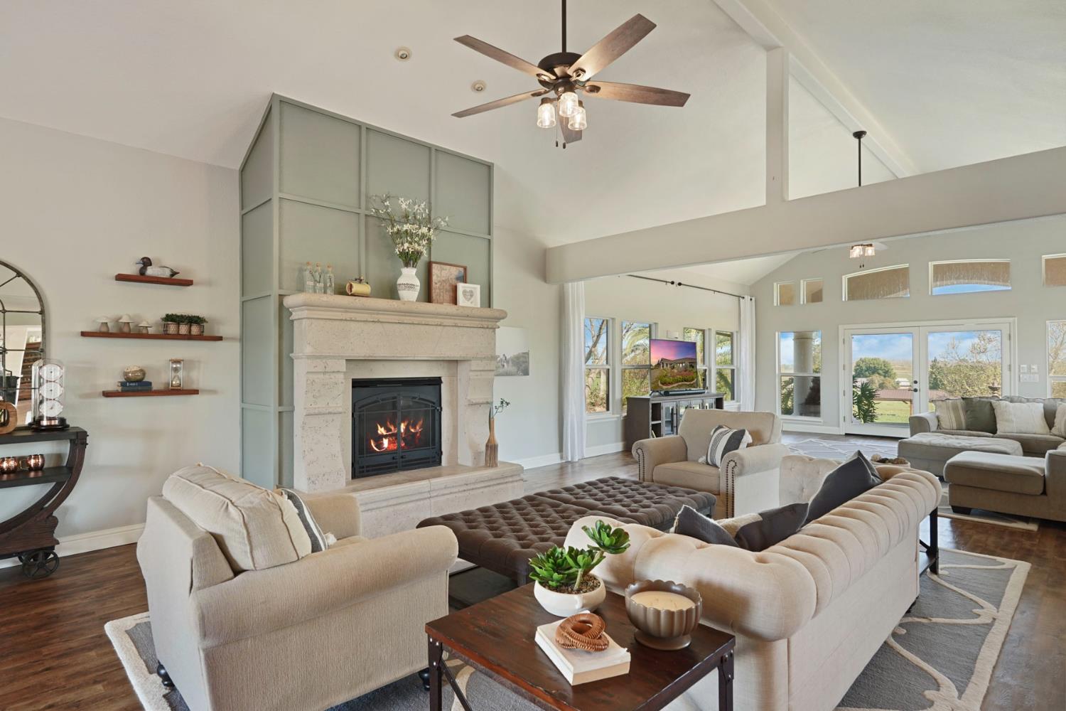 20820 East Acampo Road Clements, CA 95227 - Photo 8 of 28 a living room with furniture a fireplace and a ceiling fan