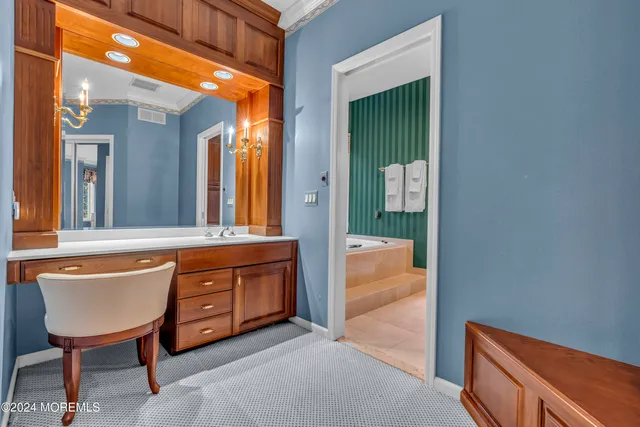 a dining room with furniture a chandelier and wooden floor