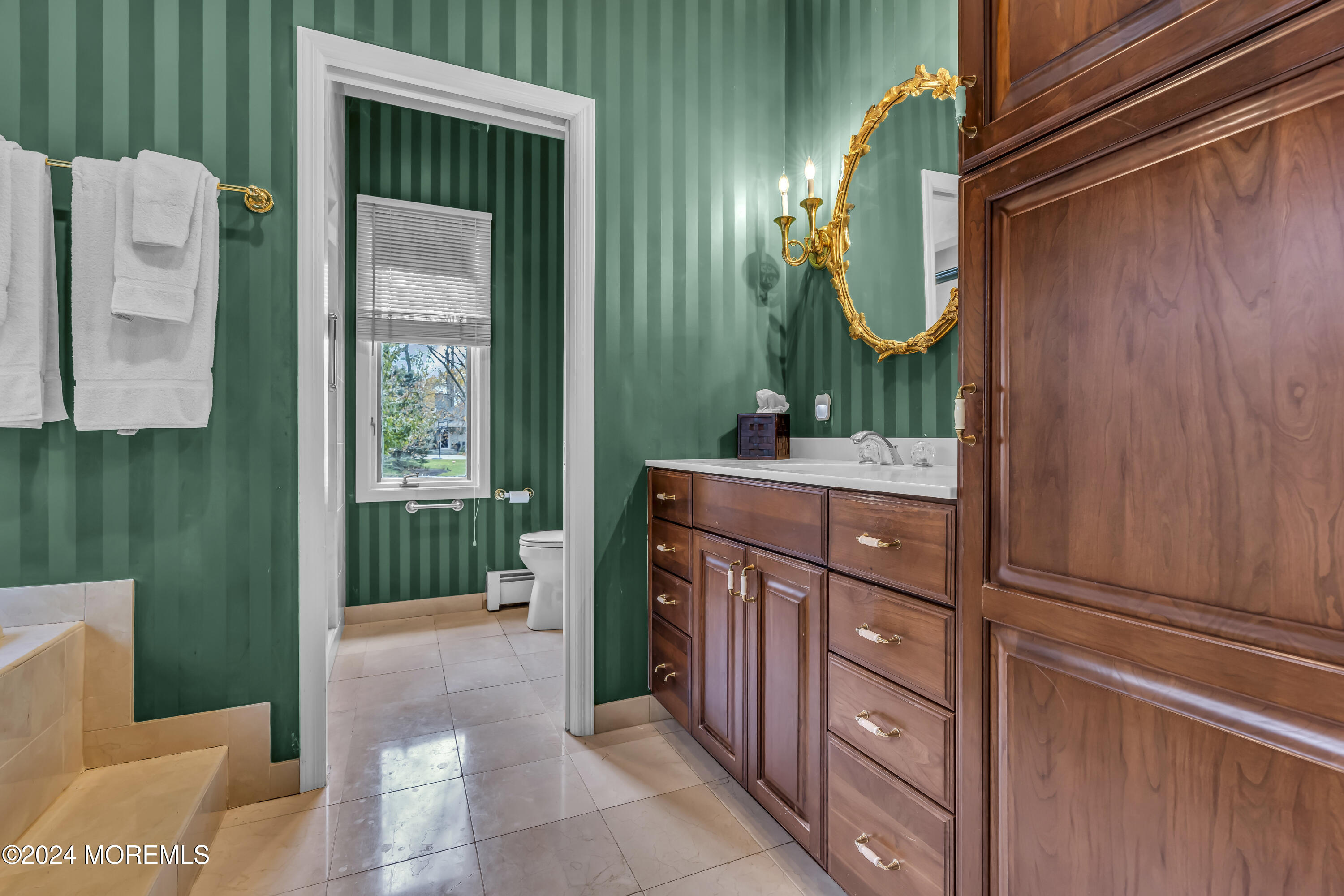 34 Bruns Road West Allenhurst, NJ 07711 - Photo 29 of 90 a bathroom with a sink a mirror and a shower