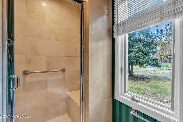 a view of staircase with wooden floor and white walls
