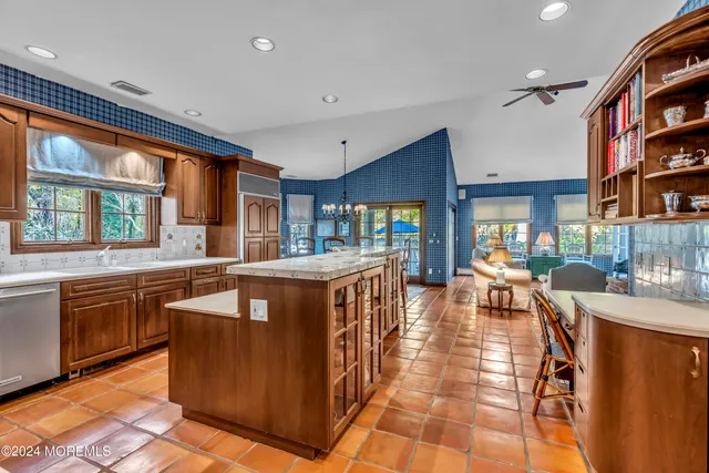a patio with table and chairs and potted plants