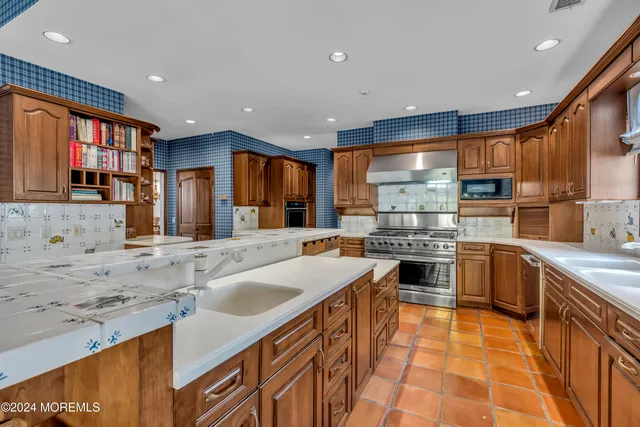 a front view of a house with a yard and trees
