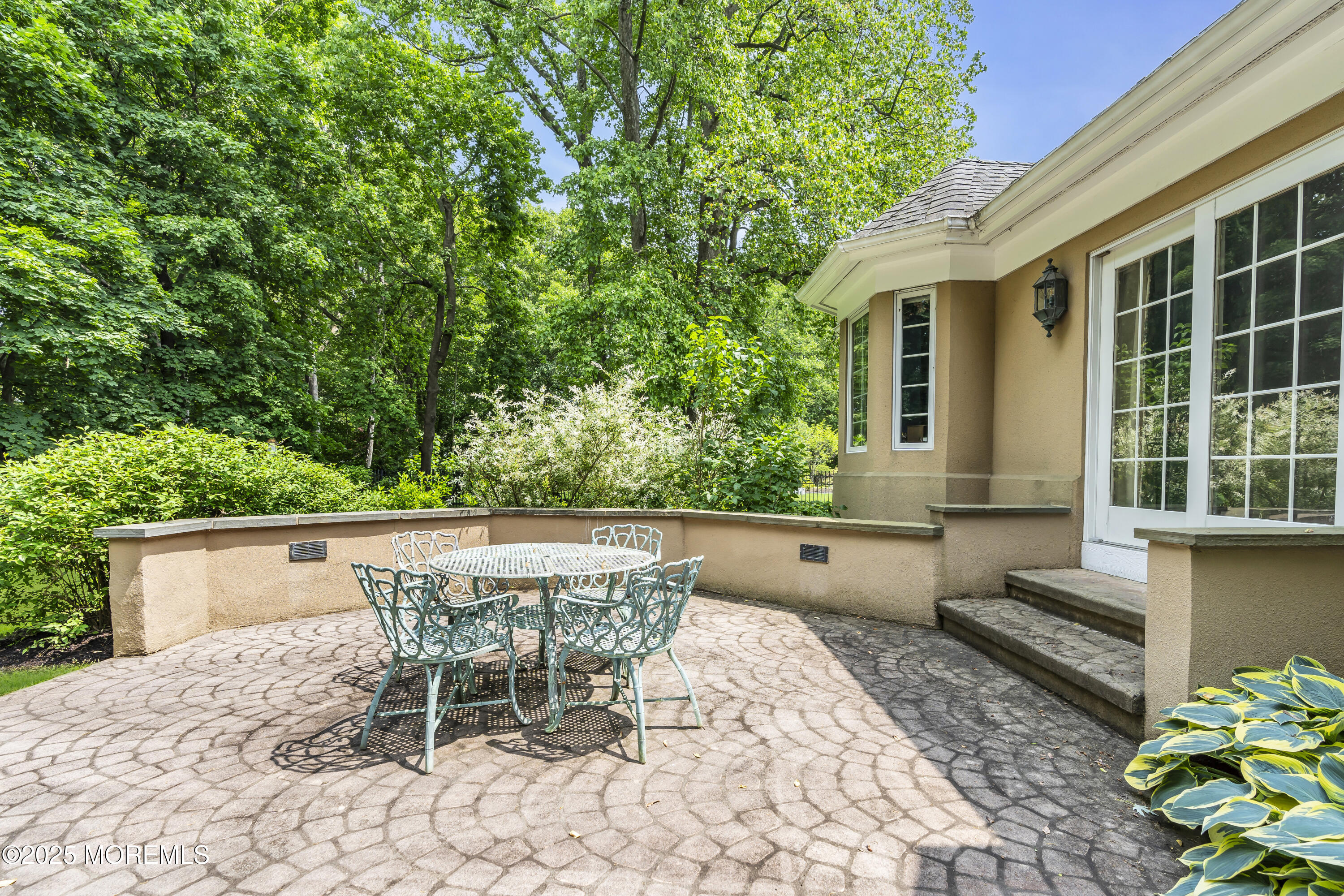 34 Bruns Road West Allenhurst, NJ 07711 - Photo 72 of 90 a patio with table and chairs and potted plants