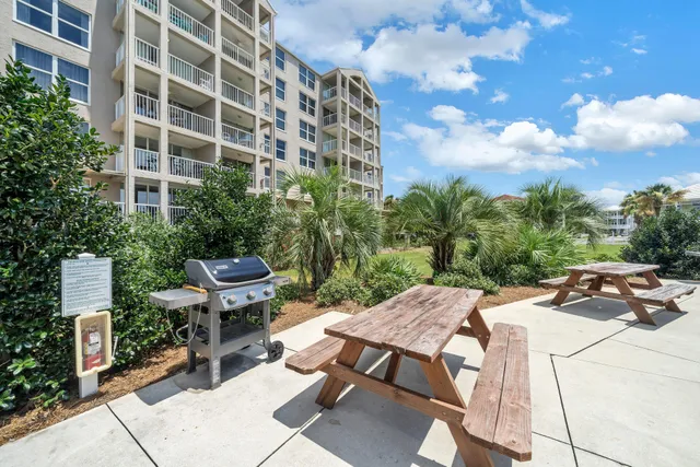 a view of a patio with table and chairs and potted plants